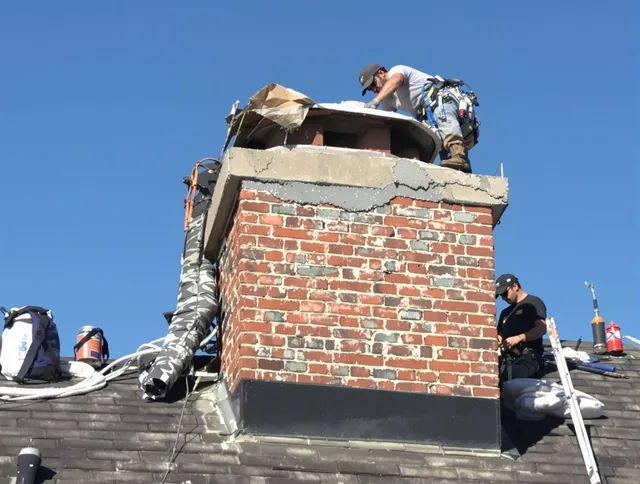 Acushnet Chimney Sweep installing a custom chimney crown in Acushnet, MA